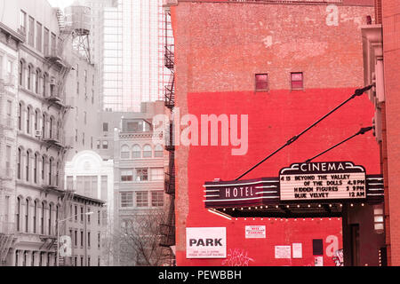 Landscape red and grey view of an old cinema from the Soho district of New York in America, with tall buildings in the background Stock Photo