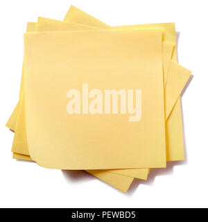 Untidy stack yellow sticky post notes isolated on white Stock Photo