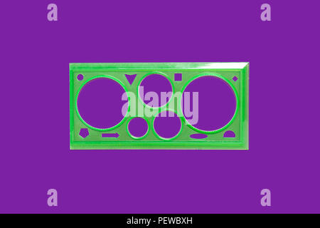 green ruler isolated on the purple surface Stock Photo