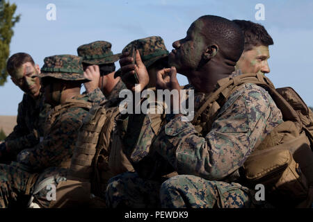 Corporal Charles Washington, student, Advanced Infantrymen Course (AIC)  2-16, Advanced Infantry Training Battalion, School of Infantry-East applies camouflage paint at Landing Zone 15 aboard Camp Geiger, N.C., Jan. 26, 2016. Infantrymen attending AIC are provided a realistic training and relevant training training and educational environment that is responsive to the needs of the operating forces. U.S. Marine Corps by SSgt Mark E. Morrow Jr, Combat Camera, SOI-E/ Released) Stock Photo