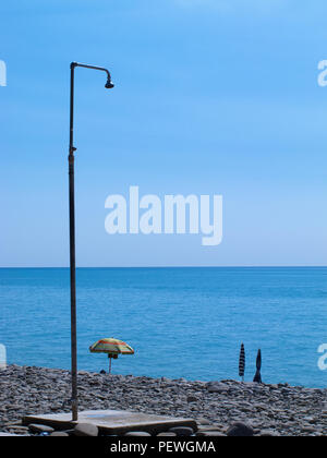 Public shower on the beach. Water jet on the shower standing on the