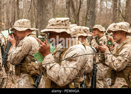 Candidates assigned to Delta Company, Officer Candidates Class-221, complete the day compass course at Brown Field, Marine Corps Base Quantico, Va., Feb. 4, 2016. In order to complete the course, the candidates first calibrated their issued lensatic compasses, then learned how to conduct a pace count on both flat and hilly terrain. (U.S. Marine Corps Photo by Cpl. Patrick H. Owens/Released) Stock Photo