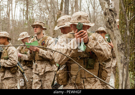 Candidates assigned to Delta Company, Officer Candidates Class-221, complete the day compass course at Brown Field, Marine Corps Base Quantico, Va., Feb. 4, 2016. In order to complete the course, the candidates first calibrated their issued lensatic compasses, then learned how to conduct a pace count on both flat and hilly terrain. (U.S. Marine Corps Photo by Cpl. Patrick H. Owens/Released) Stock Photo