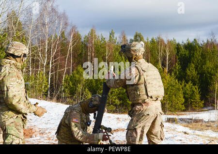 U.S. Soldiers of 3rd Squadron, 2nd Cavalry Regiment, stationed out of Vilseck, Germany, prepare to fire an 81 mm round out of an M252 mortar system during a joint training exercise at Adazi Training Area in Latvia, Feb. 4, 2016. (Photo by U.S. Army Staff Sgt. Steven M. Colvin/Released) Stock Photo