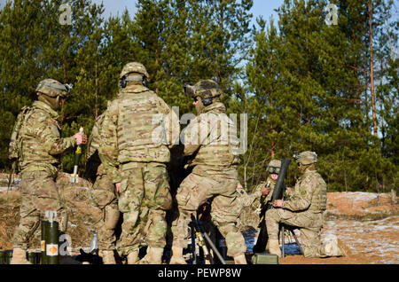 U.S. Soldiers of 3rd Squadron, 2nd Cavalry Regiment, stationed out of Vilseck, Germany, prepare to fire 81 mm mortar rounds out of M252 Mortar Systems during a joint training exercise at Adazi Training Area in Latvia, Feb. 4, 2016. (Photo by U.S. Army Staff Sgt. Steven M. Colvin/Released) Stock Photo