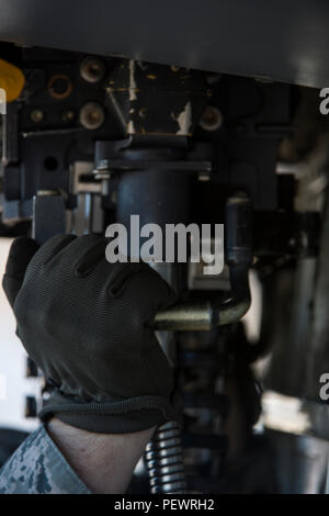 U.S. Air Force Airman 1st Class Austin Holden, a weapons load crew member assigned to the 480th Expeditionary Fighter Squadron, Spangdahlem Air Base, Germany, secures a universal ammunition loading system to the body of an F-16 Fighting Falcon fighter aircraft during a flying training deployment at Souda Bay, Greece, Jan. 29, 2016. The training allows the NATO partners to fly together to strengthen their joint military capability. (U.S. Air Force photo by Staff Sgt. Christopher Ruano/Released) Stock Photo