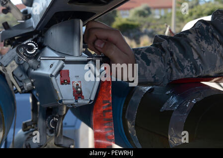 U.S. Air Force Airman 1st Class Austin Holden, a weapons load crew member assigned to the 480th Expeditionary Fighter Squadron, Spangdahlem Air Base, Germany, places a locking pin on a bomb rack attached to an F-16 Fighting Falcon fighter aircraft during a flying training deployment at Souda Bay, Greece, Jan. 29, 2016.The aircraft conducted range training as part of a bilateral deployment between the Greek and U.S. air forces to develop interoperability and cohesion between the partnering nations. (U.S. Air Force photo by Staff Sgt. Christopher Ruano/Released) Stock Photo