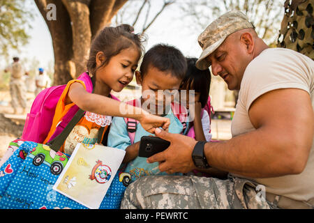 During Cobra Gold 2016 in Lop Buri, Thailand, U.S. Army engineers engaged with students at Ban Raj Bum Roong Middle School while constructing classrooms. Activities included demonstrating educational games and interacting to encourage engagement. The humanitarian civic action exercise aimed to improve educational facilities, promote learning, provide medical and community support, and strengthen regional cooperation between U.S. forces and the host nation. Stock Photo