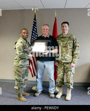 The U.S. Army Corps of Engineers (Corps) Baltimore District commander Col. Edward Chamberlayne (right) and Corps Command Sgt. Major Antonio Jones (left) honored Mr. Walter Beach, seasonal sewage and water plant operator, Tioga-Hammond & Cowanesque Lakes Project, for his heroic actions in preventing loss of life and property damage in a recognition ceremony in Tioga, Pa., Feb. 8, 2016.     Beach was praised for taking action in June 2015, when he observed a camper failed to place her vehicle in park while unlatching from her motor home in Tompkins Campground, sending the unattended vehicle on a Stock Photo