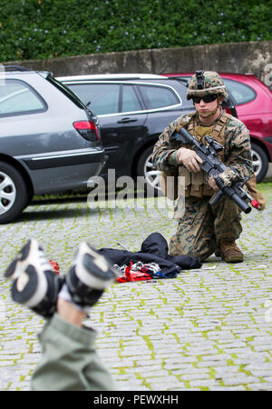 U.S. Marines with 2nd platoon Bravo company, 1st Battalion, 8th Marine Regiment, Special-Purpose Marine Air-Ground Task Force-Crisis Response-Africa detain a simulated suspect during an active shooter exercise at U.S. Embassy, Lisbon, Portugal, Feb. 9, 2016. SPMAGTF-CR-AF conducts a scaled embassy reinforcement exercise at American Embassy Lisbon in coordination with the Regional Security Office and host nation security forces in order to enhance mission essential  task proficiency and build relationships. (U.S. Marine Corps photo by Sgt. Kassie L. McDole/Released) Stock Photo