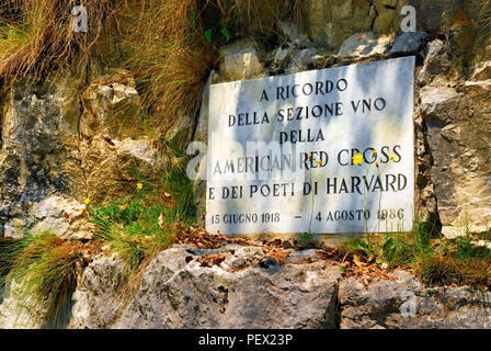 Veneto,Italy. Pove del Grappa : the plaque in memory of the ambulance drivers of the American Red Cross. During the last months of the Battle of Mount Grappa, the writers Ernest Hemingway, John Howard Lawson and John Dos Passos were assigned to the ambulance service. Bassano del Grappa was the seat of the First Section of the American Red Cross. By chance, an exceptional group of  American men of letters that would become very famous after the war, met there as voluntary ambulance drivers. Stock Photo