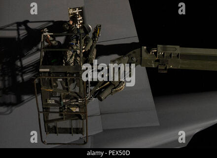 Staff Sgt. Mark Rippy, air reserve technician hydraulics specialist, 315th Maintenance Squadron, working with the 437th MXS and Senior Airman Skyler Ayers, a crew chief working in the repair and reclamation flight remove a panel to inspect the component integrated flight control module located above it in order to troubleshoot a flight control system fault that has been isolated to one of four tail elevator IFCMs, causing an unsafe condition on a transient C-17 Globemaster III cargo aircraft on the flightline at Joint Base Charleston, S.C. Left uncorrected, the fault can cause uncommanded actu Stock Photo