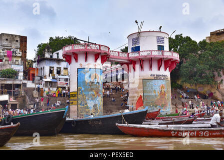 Buildings and ghat along Ganges river with people and boats Stock Photo