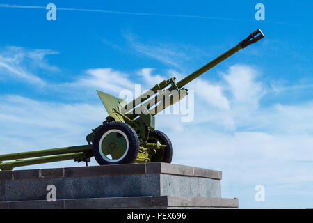 artillery cannon of the great Patriotic war stands against the blue sky Stock Photo