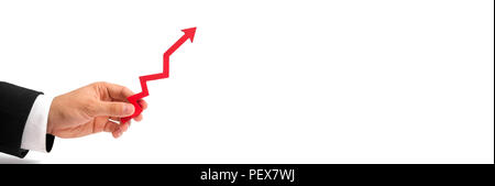 A businessman's hand holds a red arrow up on a white background. The concept of raising and multiplying income and profits, rising prices and salaries Stock Photo