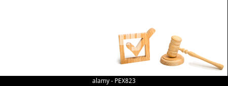 A wooden checkmark and a hammer of the judge on a white background. referendum and elections. Appointment of a judge, election to a constitutional cou Stock Photo