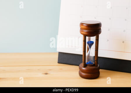 Calendar and hourglass on table, Business schedule and time concept Stock Photo