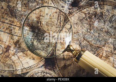 View through magnifier on old map, showing "America" word. Stock Photo