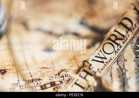 View through magnifier on old map, showing "World" word. Stock Photo