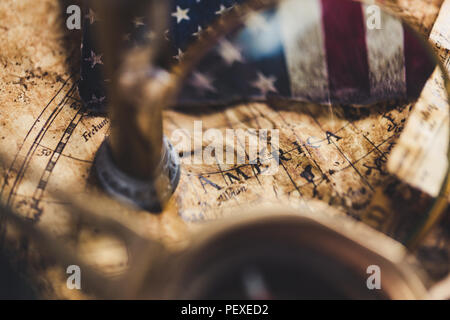 View through magnifier on old map, showing "America" word. Stock Photo