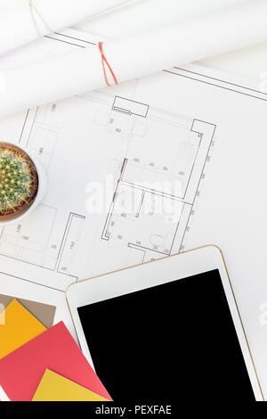 Creative flat lay overhead top view blueprints architectural flat project plan and office supplies on decorator white table workspace with swatches to Stock Photo