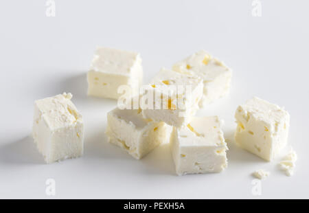 Feta cheese cubes on white background with selective focus and space for text Stock Photo