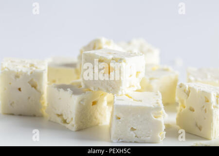 Feta cheese cubes isolated on white background with selective focus Stock Photo