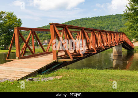 SMETHPORT, PA, USA-11 AUGUST A footbridge across Potato Creek, which feeds Hamlin Lake in Smethport. Stock Photo