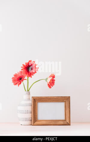 White landscape frame mock up with a vase of gerbera beside the frame, overlay your quote, promotion, headline, or design, great for small businesses, Stock Photo