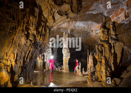 Two men are exploring the Krizna Jama cave. Karst region, Slovenia. Stock Photo