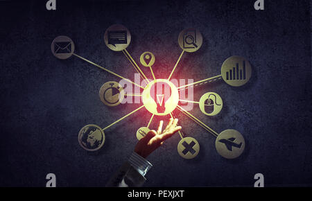 Close of businessman hand showing at user interface glowing on wall Stock Photo