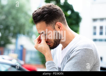Close-up Of A Young Man Suffering From Headache Stock Photo