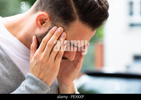 Close-up Of A Young Man Suffering From Headache Stock Photo
