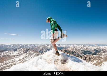 Hiker stretching on mountain peak, La Plata Mountains, Colorado, USA Stock Photo