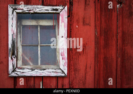 White-framed window on an old red barn. Stock Photo