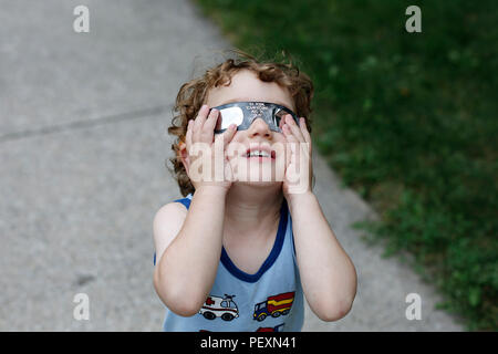 Boy watching solar eclipse Stock Photo