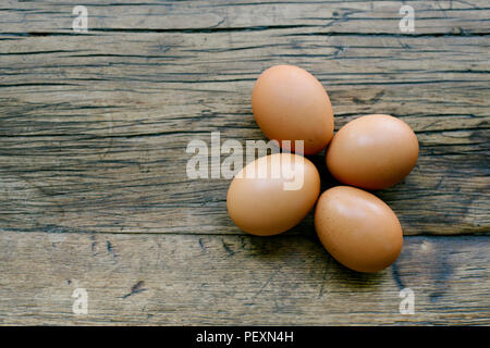 Top view of 4 fresh eggs on a farm table with copy space Stock Photo