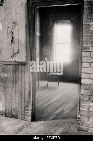 Interior with light from window hitting chair, in the Ghost Town of Garnet in Montana Stock Photo