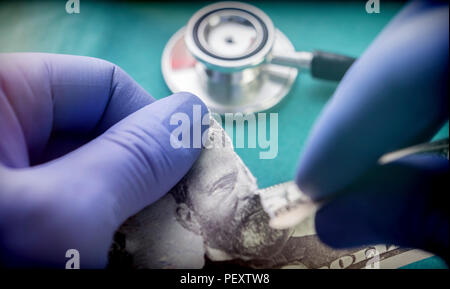 Doctor breaks a ticket of dollar, conceptual image Stock Photo