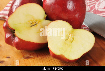 Red delicious apples sliced on a cutting board Stock Photo