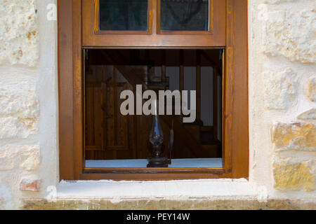 lantern lamp light in wooden window on wooden old stairs background Stock Photo