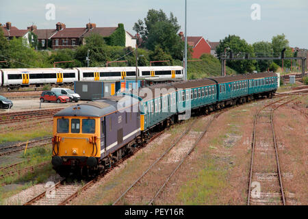 A class 73 electro-diesel locomotive number 73212 and preserved class 424 4-Vep electric multiple unit number 3417 wait to depart Tonbridge Yard. Stock Photo