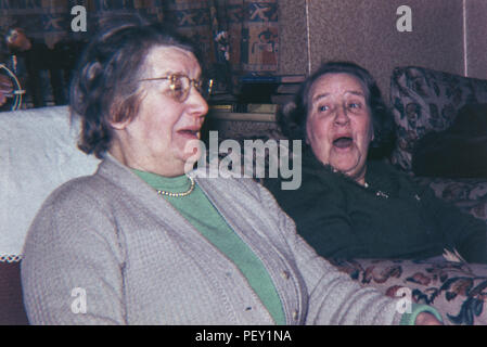 Two old women laughing with each other. Image taken 1960s/70s Stock Photo