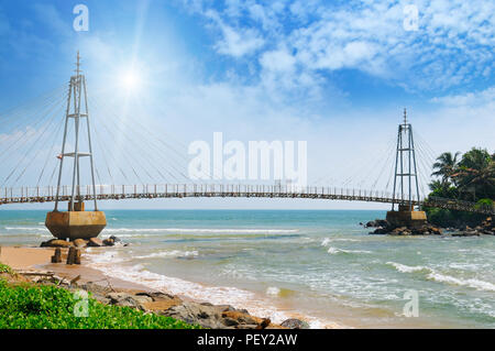 bridge to island, ocean and sun in blue sky (Matara, Sri Lanka) Stock Photo