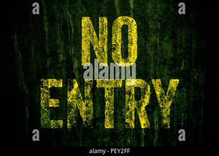 “No Entry” warning sign in yellow letters painted over dark grungy concrete wall with green moss. Sign as concept for: do not enter the area, caution, Stock Photo