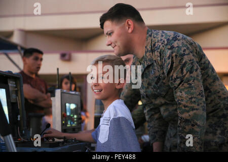 An EOD technician demonstrates TALON robot operation to a student at Condor Elementary School’s annual Science Night at MCAGCC on Feb. 9, 2016. Students learn about robotics, electronics, and ordnance disposal operations in a hands-on setting. The event includes STEM-focused activities designed to educate children and families about technology, engineering principles, safety, and problem-solving skills through interactive demonstrations and guided instruction by Marines and technicians. Stock Photo