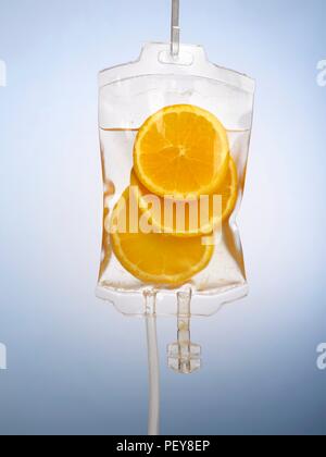 IV bag with orange slices, studio shot. Stock Photo