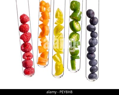 Fruits and vegetables in test tubes, studio shot. Stock Photo