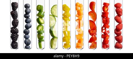 Fruits and vegetables in test tubes, studio shot. Stock Photo