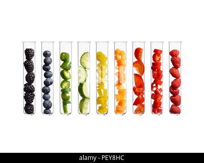 Fruits and vegetables in test tubes, studio shot. Stock Photo